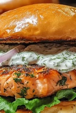 Delicious homemade salmon burgers with lemon dill sauce on a plate.