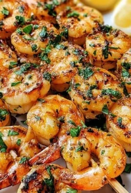Garlic Butter Grilled Shrimp Skewers on a grill, showcasing delicious seafood recipe.