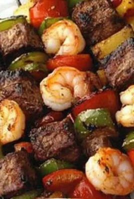 Grilled steak and shrimp kabobs on a skewer ready for serving