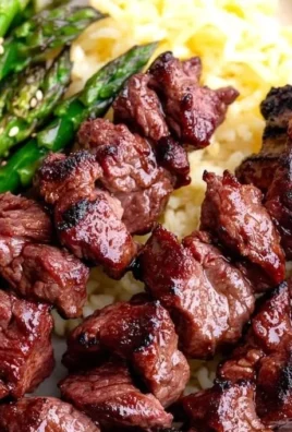 Delicious healthy grilled teriyaki steak kabobs on skewers, garnished with vegetables