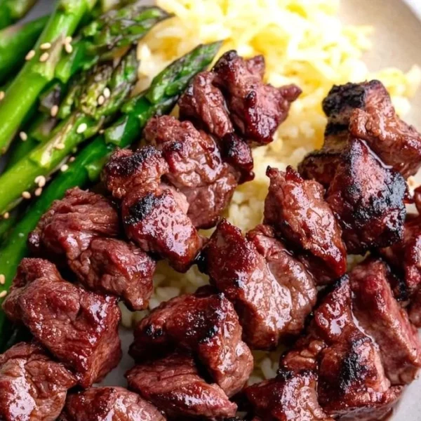 Delicious healthy grilled teriyaki steak kabobs on skewers, garnished with vegetables