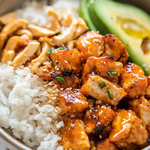 Delicious Hot Honey Chicken Bowls topped with fresh vegetables and sauce