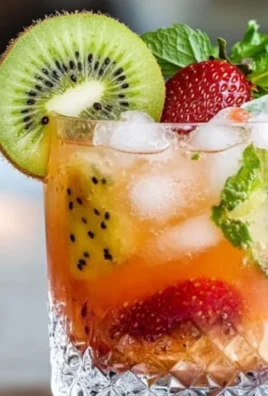 Refreshing Kiwi Strawberry Smash Mocktail in a glass with garnishes
