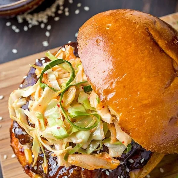 Korean BBQ Burger topped with traditional ingredients and served on a toasted bun