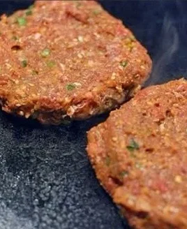 Plate of Korean mini burger patties garnished with fresh vegetables