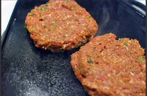 Plate of Korean mini burger patties garnished with fresh vegetables
