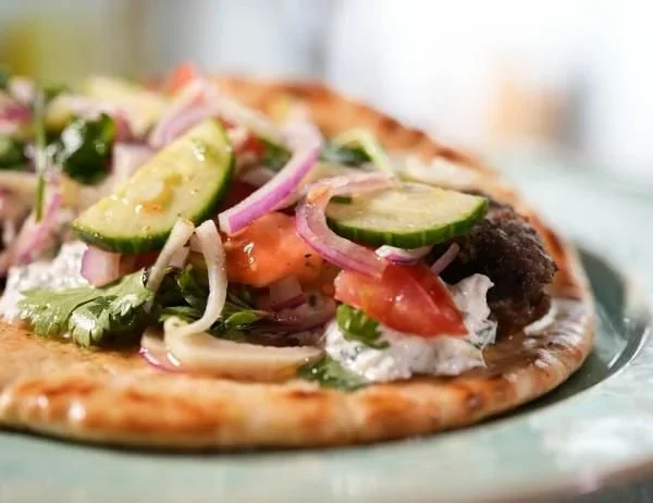 Tender lamb skewers served in pita bread with fresh toppings