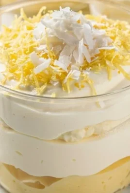 Lemon Coconut Cream dessert topped with coconut flakes and lemon zest.