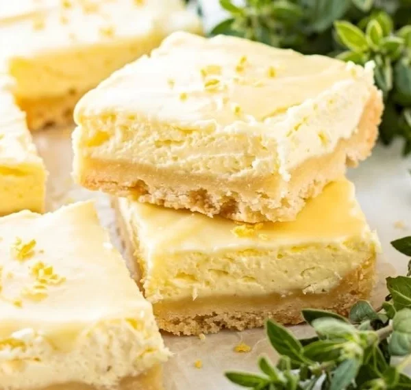 Homemade lemon nettle dessert bars garnished with fresh herbs.