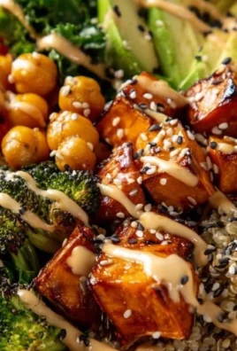 Miso glazed sweet potato Buddha bowl with colorful vegetables and grains