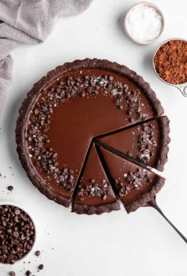 Delicious no-bake vegan chocolate tart topped with fresh berries