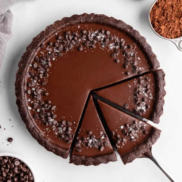 Delicious no-bake vegan chocolate tart topped with fresh berries