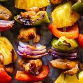 Pineapple Teriyaki Chicken Skewers on a grill, showcasing delicious tender chicken and pineapple