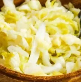 Homemade raw sauerkraut in a jar, showcasing its vibrant, fermented texture.