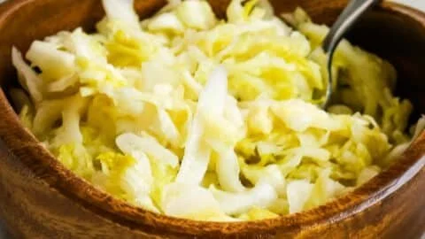 Homemade raw sauerkraut in a jar, showcasing its vibrant, fermented texture.
