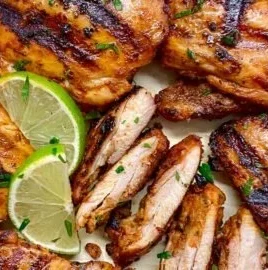 Juicy roast chicken seasoned in Chipotle style, served on a platter.