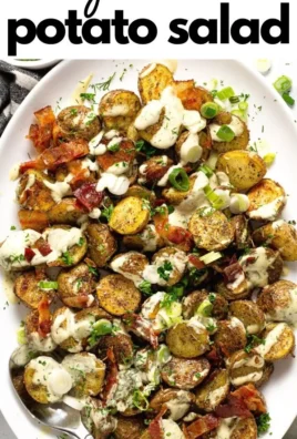 A vibrant bowl of Roasted Potato Salad with colorful vegetables and herbs.