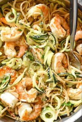 Plate of Shrimp Scampi Pasta with Zucchini Noodles garnished with herbs