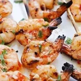 Sweet Chili Shrimp Skewers served on a platter with dipping sauce