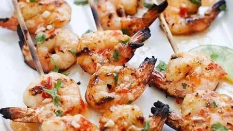 Sweet Chili Shrimp Skewers served on a platter with dipping sauce