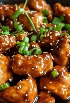 Delicious homemade teriyaki chicken garnished with sesame seeds and green onions