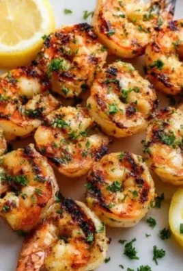 Juicy grilled shrimp from Texas Roadhouse served with lemon and seasoning
