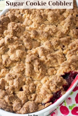 Triple Berry Sugar Cookie Cobbler topped with fresh berries and a cookie crust