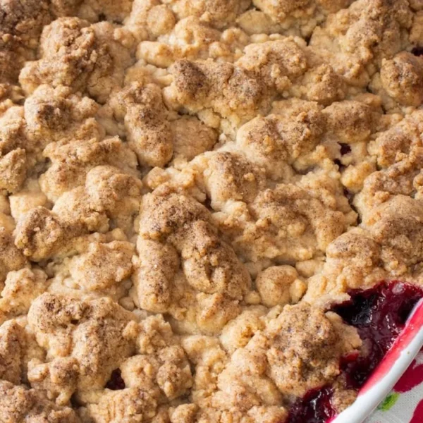 Triple Berry Sugar Cookie Cobbler topped with fresh berries and a cookie crust