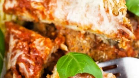 Gluten-free Baked Eggplant Parmesan served with fresh herbs