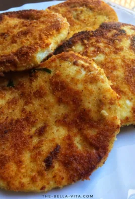 Crispy breaded eggplants served on a plate with dipping sauce