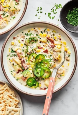 Bowl of rich and creamy clam chowder topped with parsley