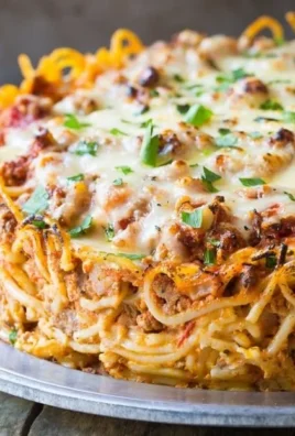 Cozy baked spaghetti pie with melted cheese and herbs in a rustic dish