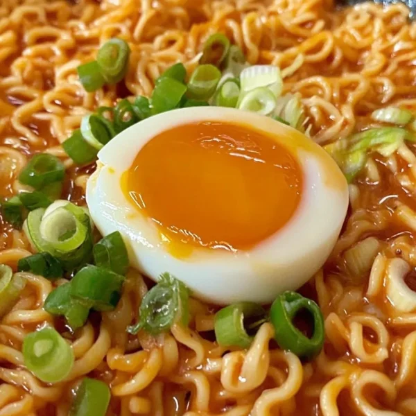 Creamy Buldak Noodles served in a bowl with colorful ingredients