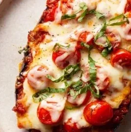 Crispy baked eggplant parmesan served with fresh basil and marinara sauce