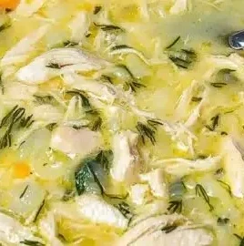 Bowl of Easy Avgolemono, Greek lemon soup with a creamy texture and lemon garnish.