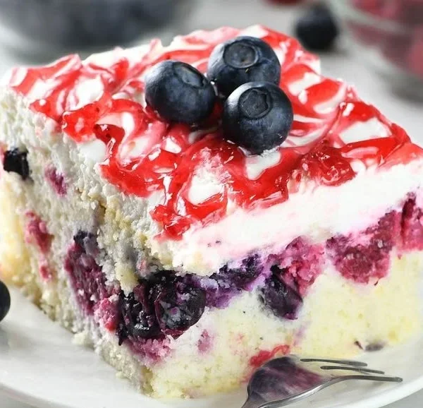 Easy summer berry sheet cake topped with fresh strawberries, blueberries, and raspberries