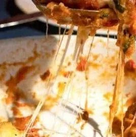 Delicious Eggplant Parmesan with layers of eggplant, marinara sauce, and mozzarella cheese.