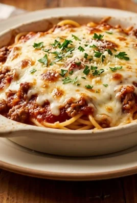 Delicious Fazoli's Baked Spaghetti topped with cheese and marinara sauce