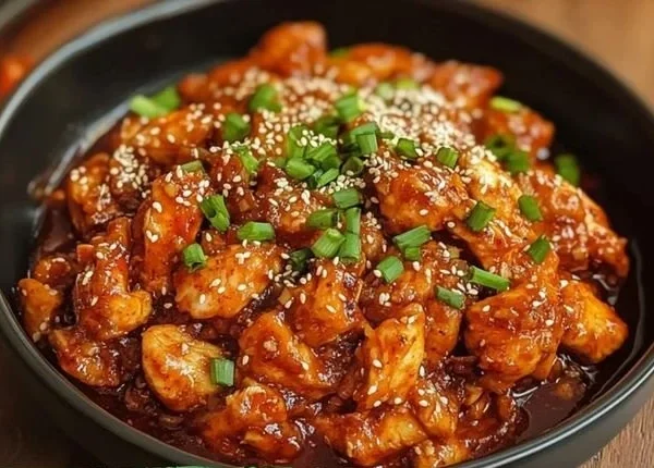 Delicious serving of Korean Fire Chicken, garnished and ready to enjoy