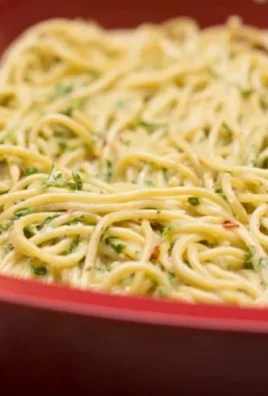 Delicious leftover pasta frittata served on a plate with fresh herbs.