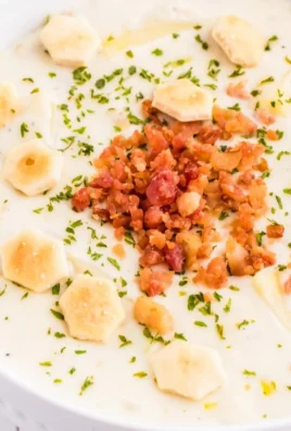 Bowl of creamy New England clam chowder with clams and potatoes