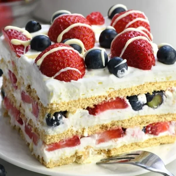 No-Bake 4th of July Icebox Cake decorated with berries and whipped cream