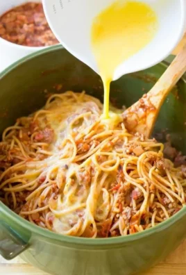 Delicious spaghetti pie served on a plate with a garnish