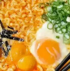 Delicious bowl of Spicy Cheese Ramen topped with cheese and chili flakes.