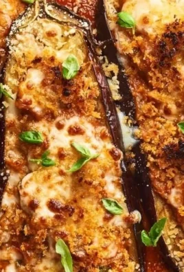 Delicious stuffed eggplant parmesan dish topped with melted cheese and herbs.